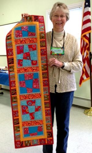 Anne Sigler of Warwick Valley Quilt Guild with her finished Nine-Patch Skinny Quilt